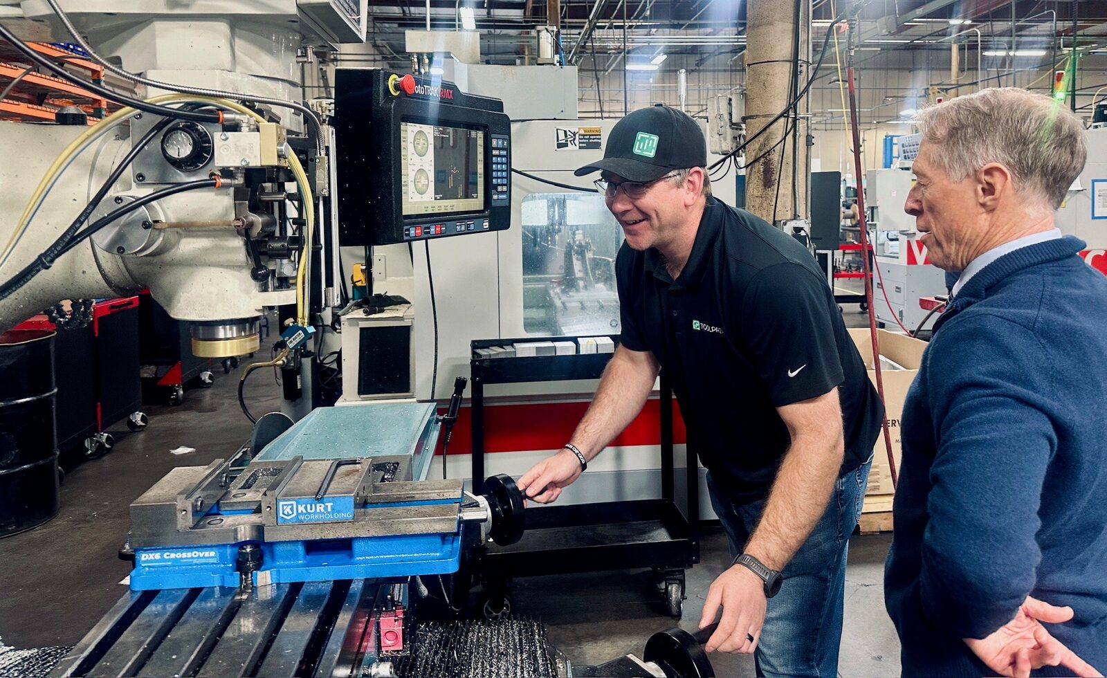Master machinists reviewing a part